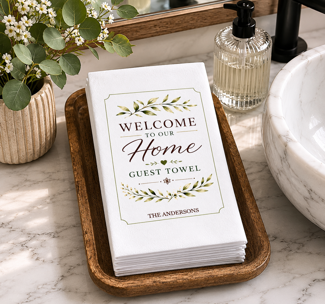 Elegant personalized guest towel display styled on a rustic wooden tray beside a modern bathroom sink with warm farmhouse-inspired décor.