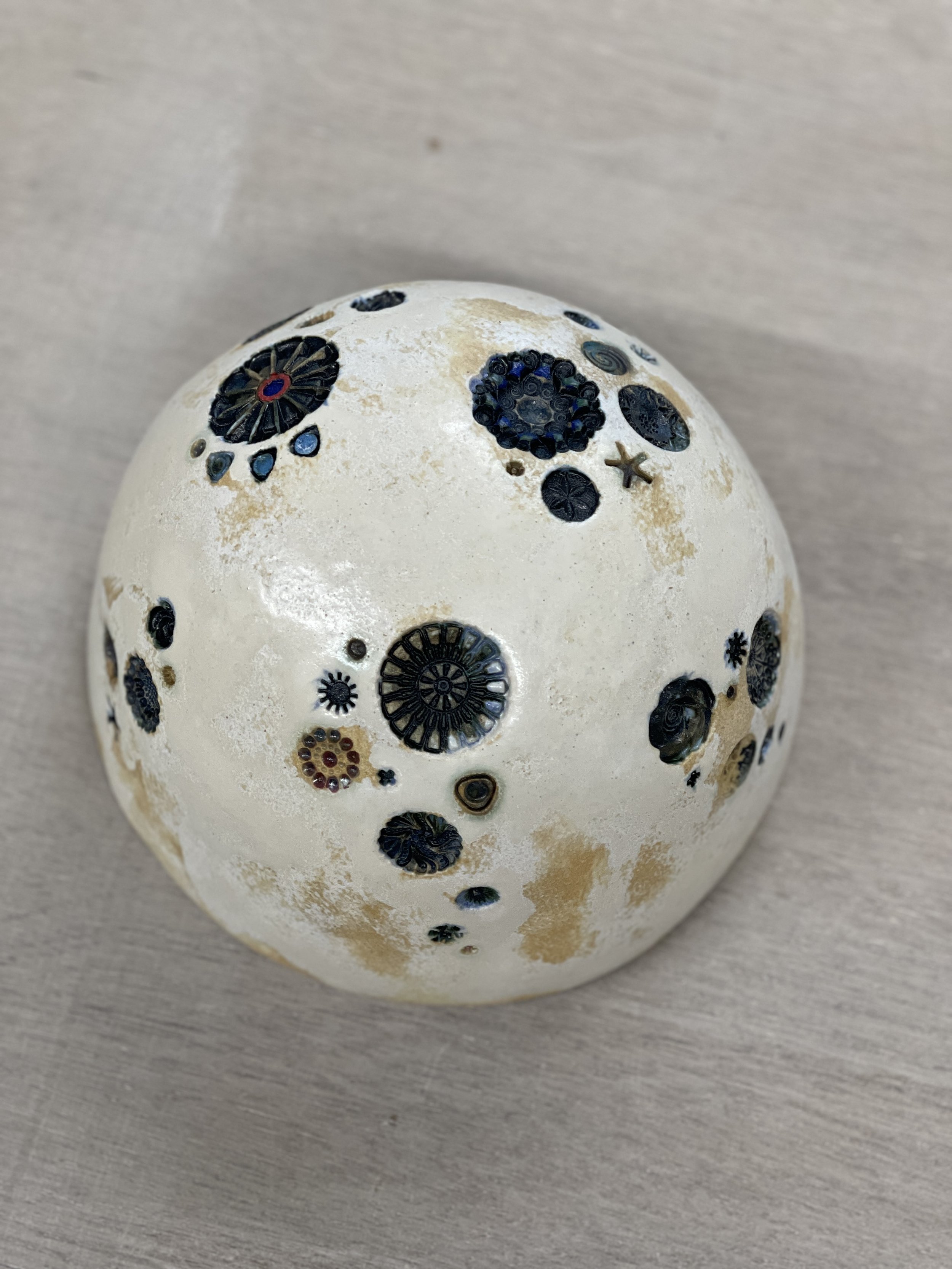 Helen works wonders with stamps, oxides and a touch of underglaze. This dome is Almond White.