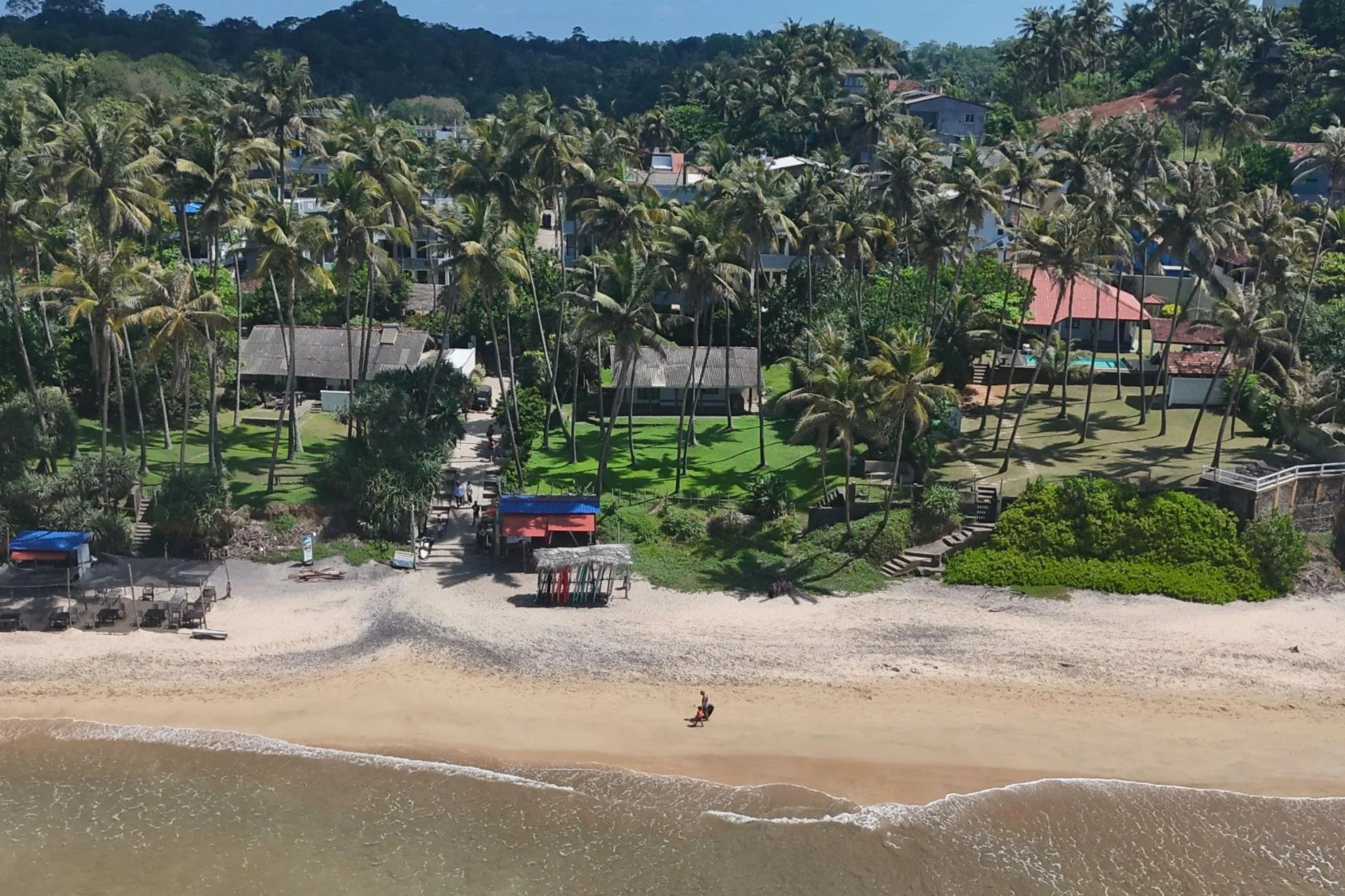  An aerial image of a beach house for sale along a beautiful stretch of southern coastline in Sri Lanka. 