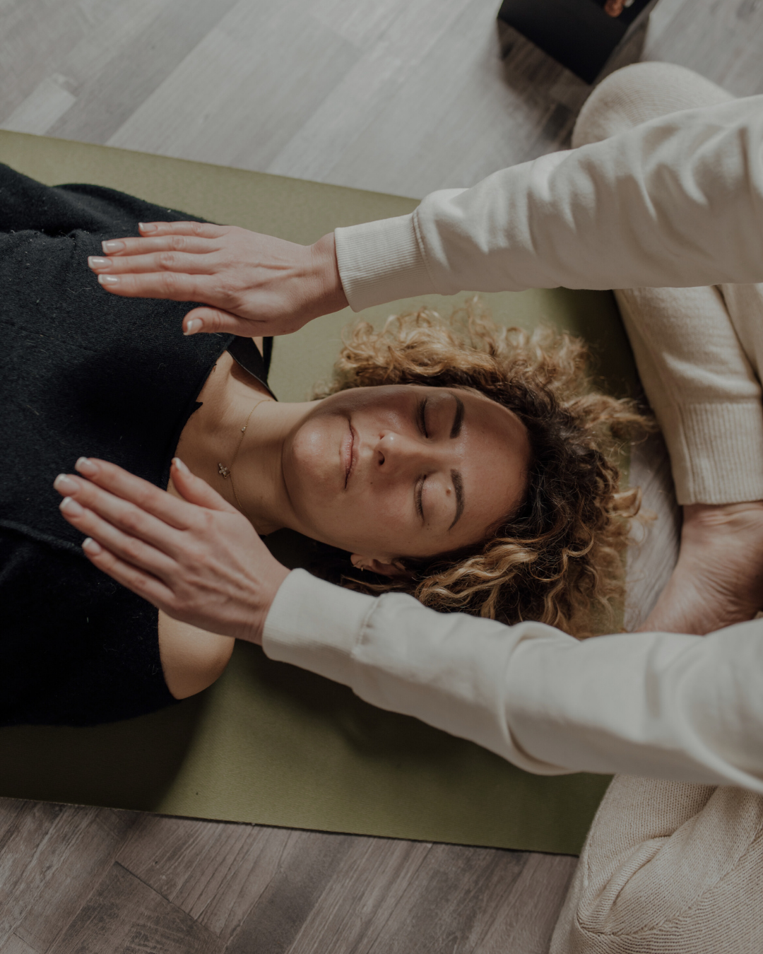 Person receiving reiki energy healing in a calm, supportive healing environment