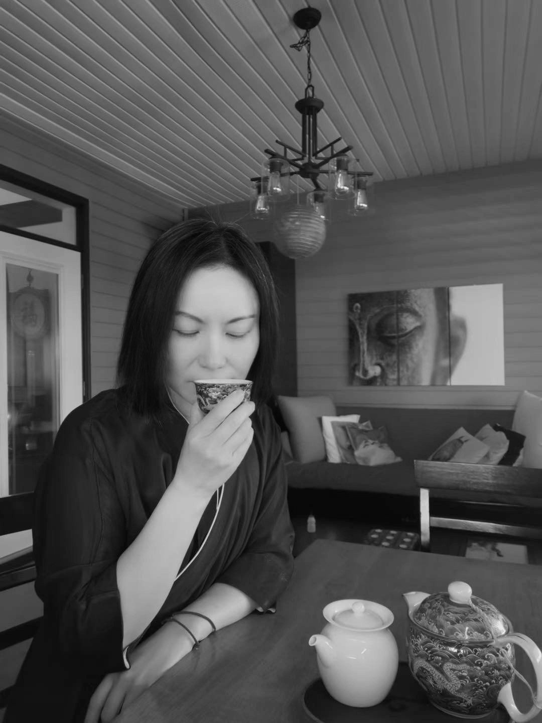 JJ in a cozy setting, sipping tea and offering a peaceful moment of reflection and presence
