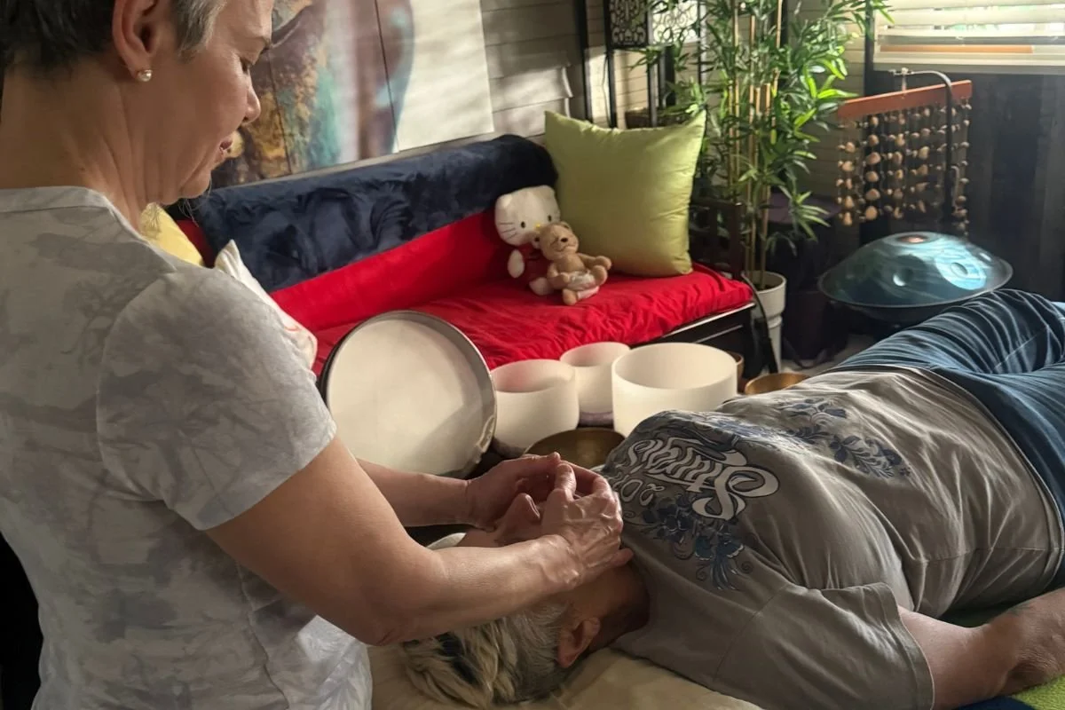 Reiki student practising hands-on healing on another student during Reiki class in Vancouver BC