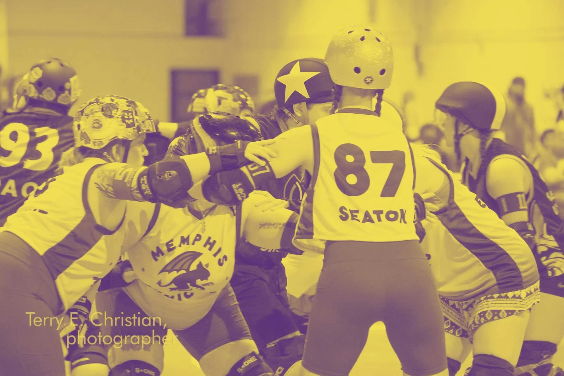 Roller derby players are engaged in a jam, with some players attempting to block or pass, wearing helmets and protective gear, with a focus on the Minion team. The image has a yellow tint smothering the scene.