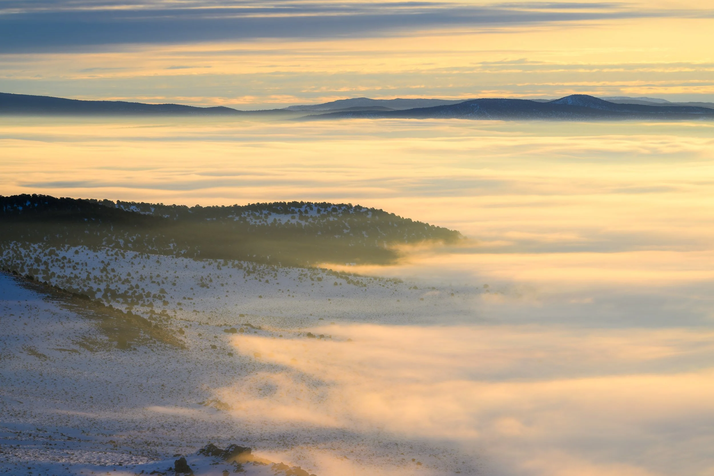 Mono Lake Basin above the Clouds
A thick winter cloud inversion settles into the Mono Lake Basin, leaving nothing but a smooth layer of clouds filling the valley below. From the overlook off Highway 395, the whole basin feels hidden under a soft whit