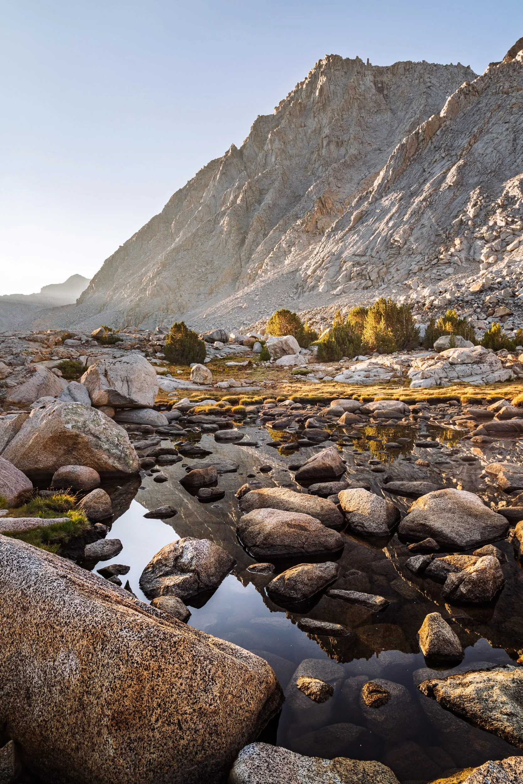 Fractured Reflection
Sunrise on Mount Mendel as seen from the Darwin Bench, Kings Canyon National Park. The rugged, boulder-strewn tarn in the foreground breaks up the morning reflection, serving as a silent reminder of the glacial forces that shaped