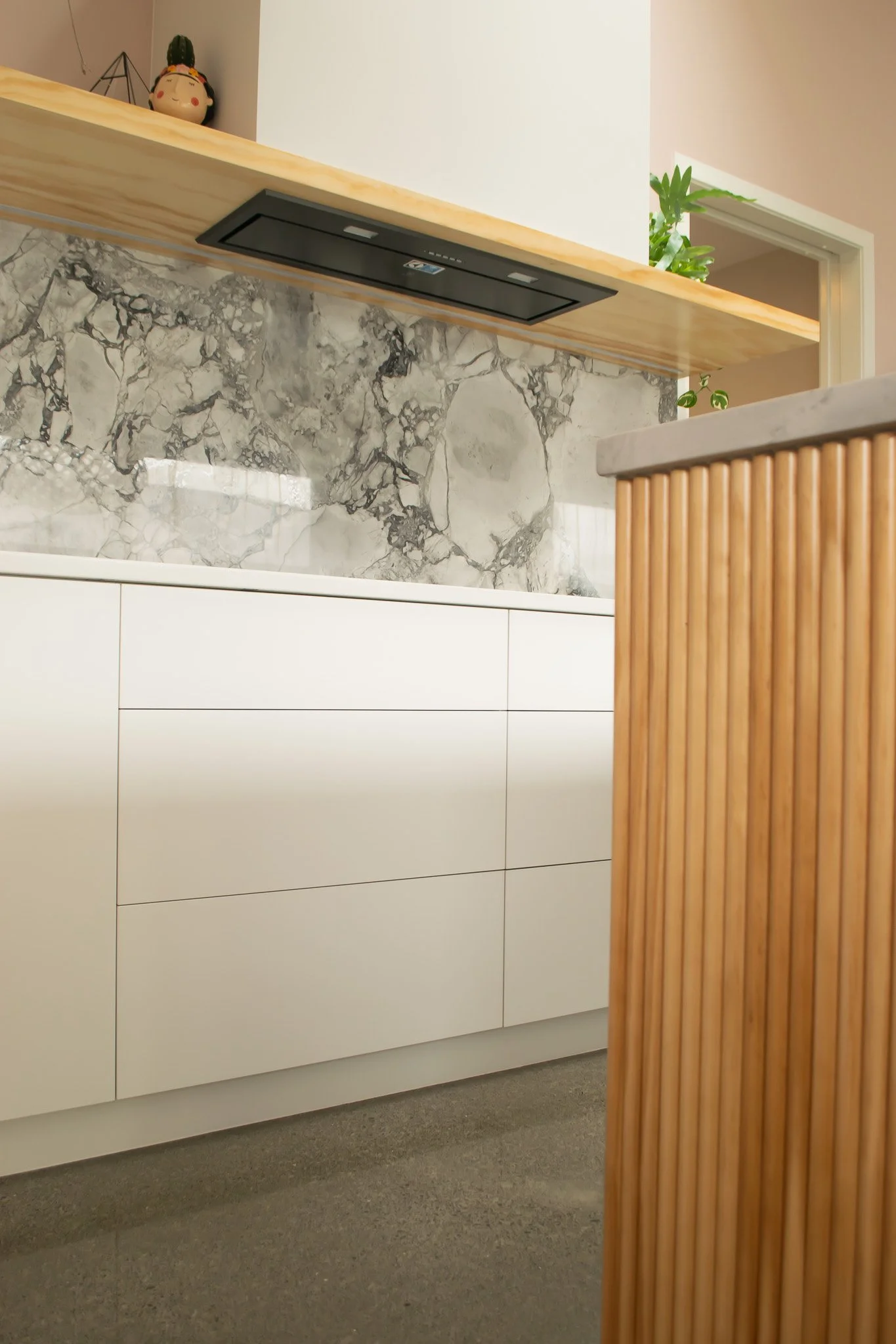Fresh By Design Interiors
Modern kitchen design wood fluting and pink walls marble counter