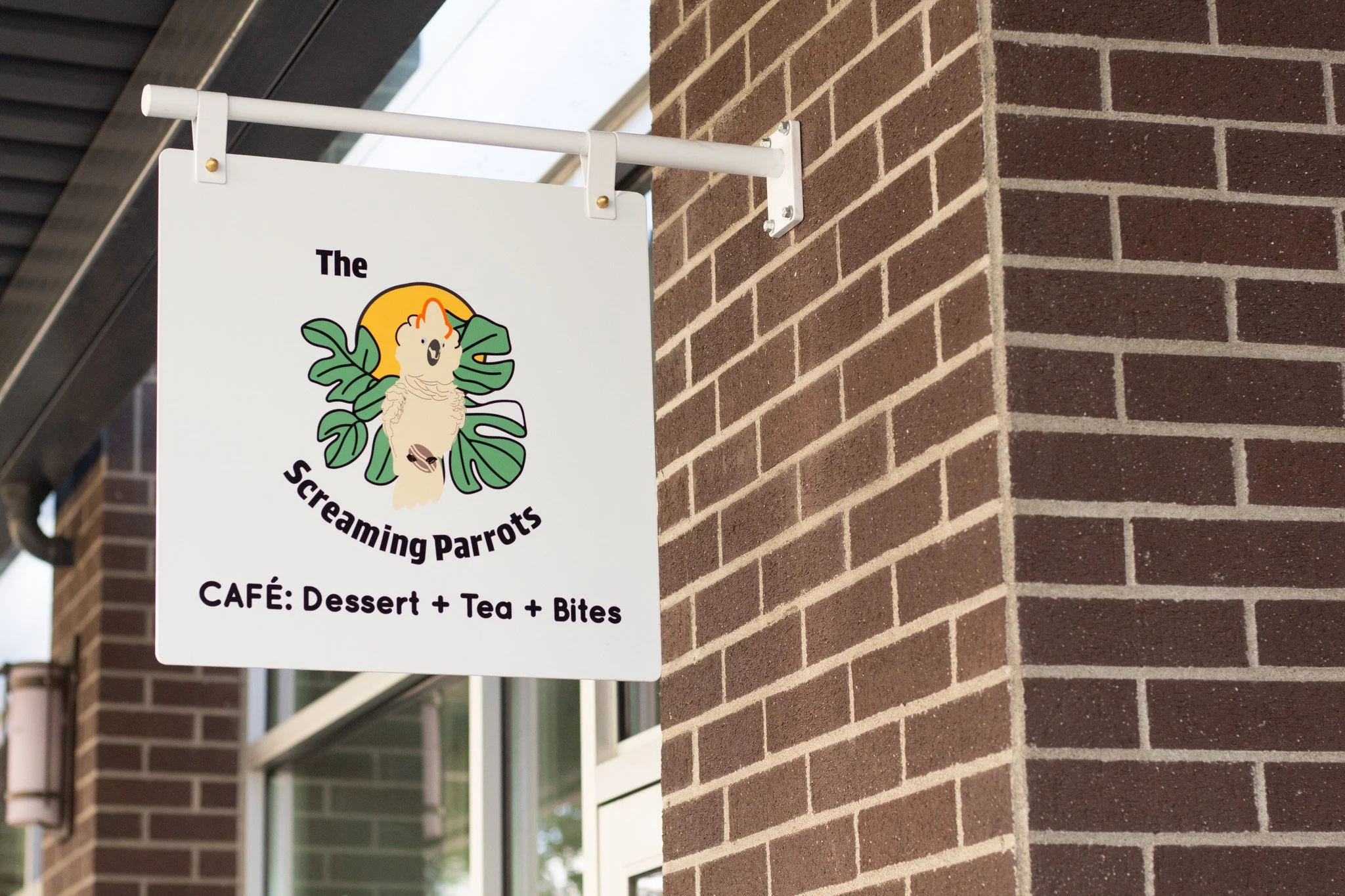 The Screaming Parrots Cafe sign hanging out front.