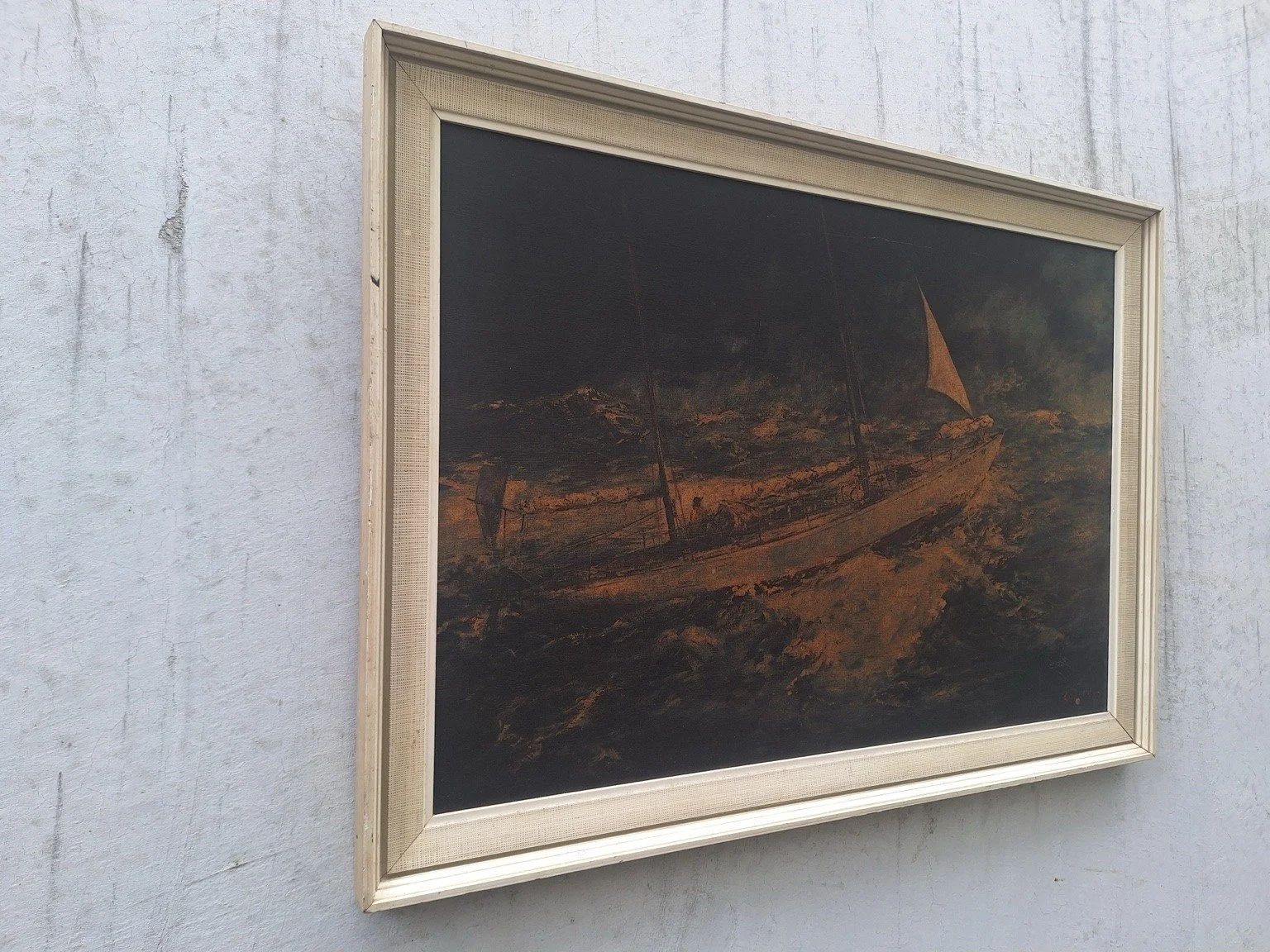 Right angled view of the framed ship print with warm amber waves and a dark sky.