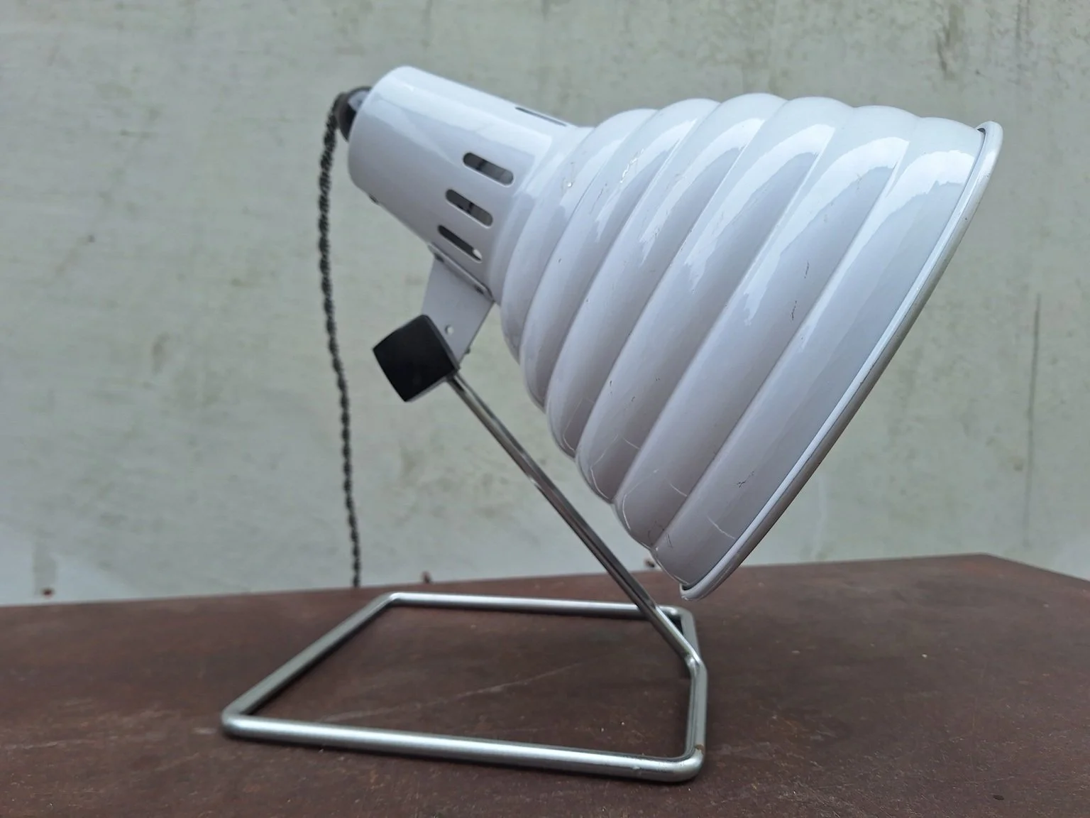 Opposite side of Pifco lamp showing black adjustment knob and wire stand.