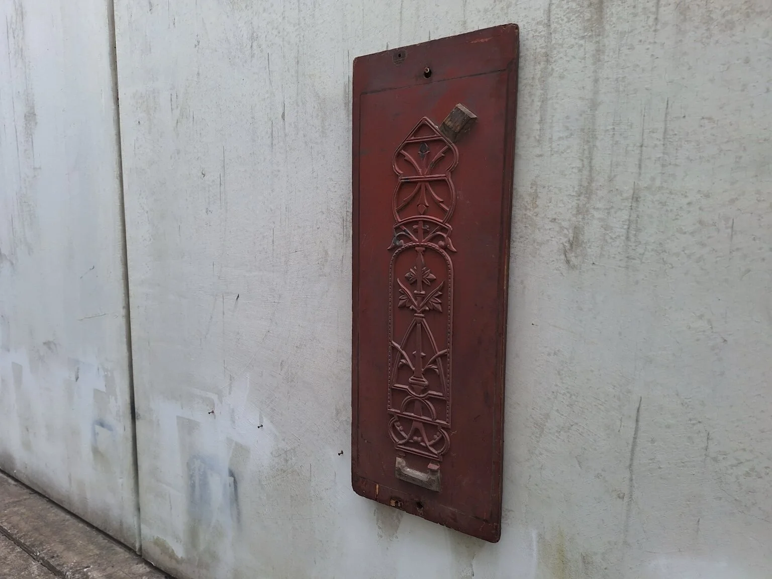 Opposite angled view of the tall red-brown industrial casting pattern