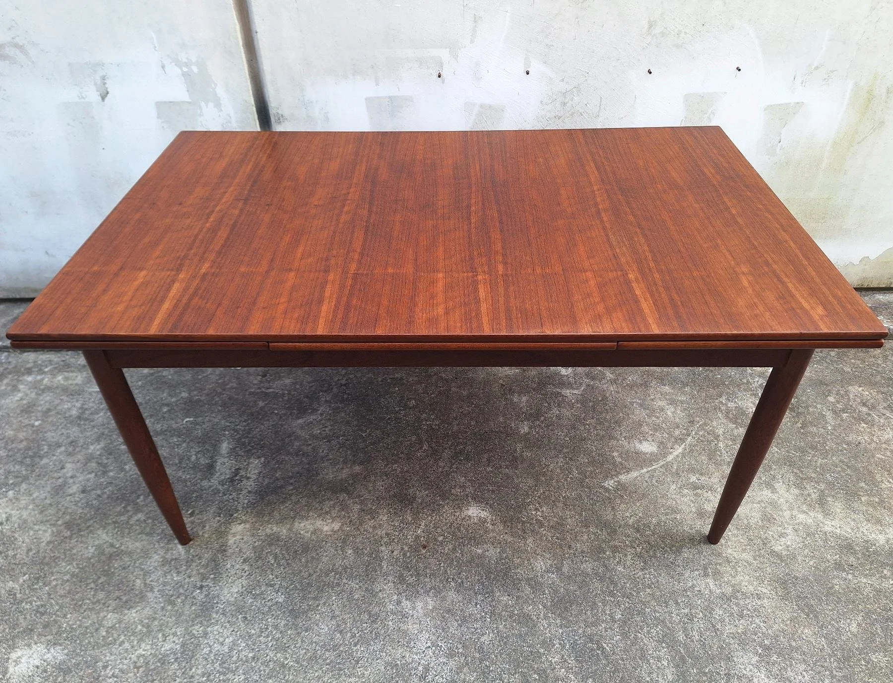 DQF blackbean extension dining table shown closed from the front.