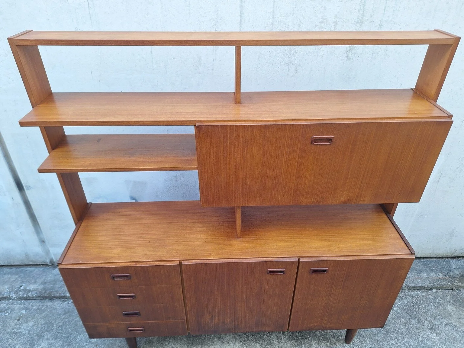 Upper shelving and closed drop-down bar compartment of the vintage wall unit