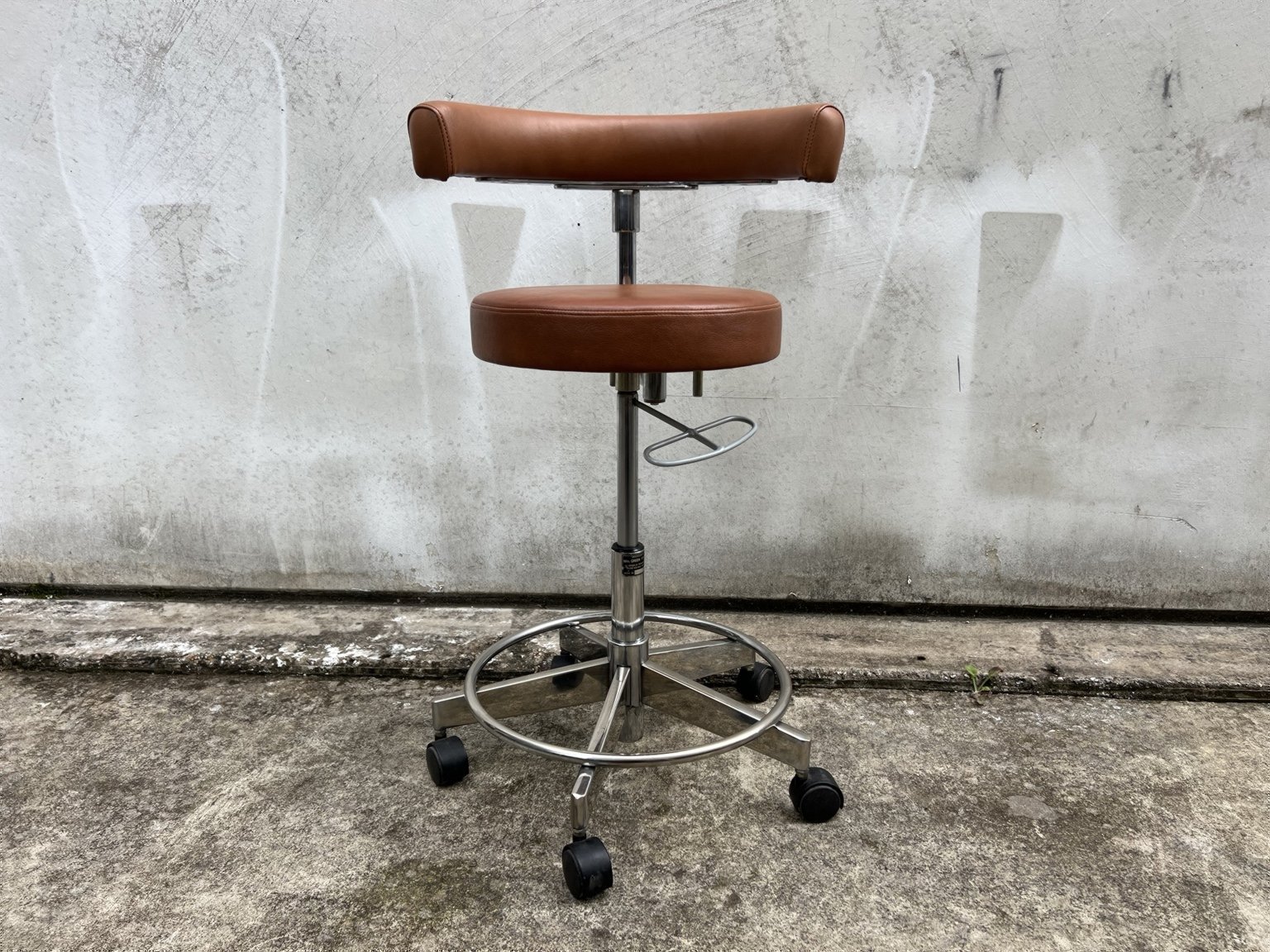 Mid century adjustable stool with tan leather seat and chrome base