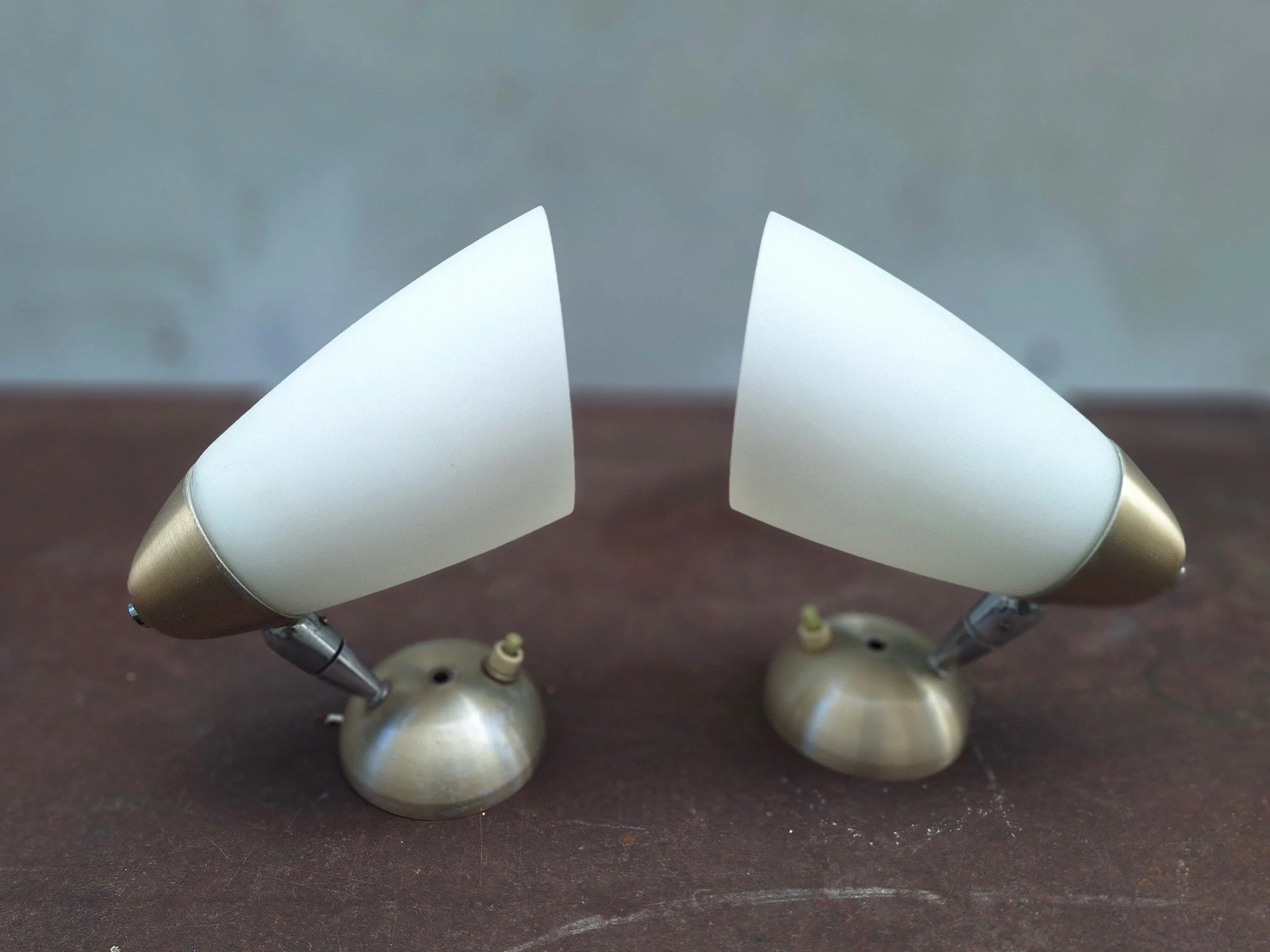 Pair of vintage adjustable wall light fittings with frosted white conical shades, anodised aluminium end caps and wall mounts, and articulated chrome arms.