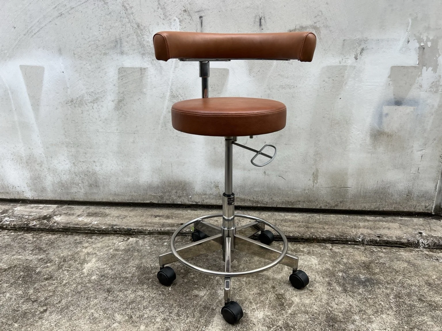 Mid century adjustable stool with tan leather seat and chrome base