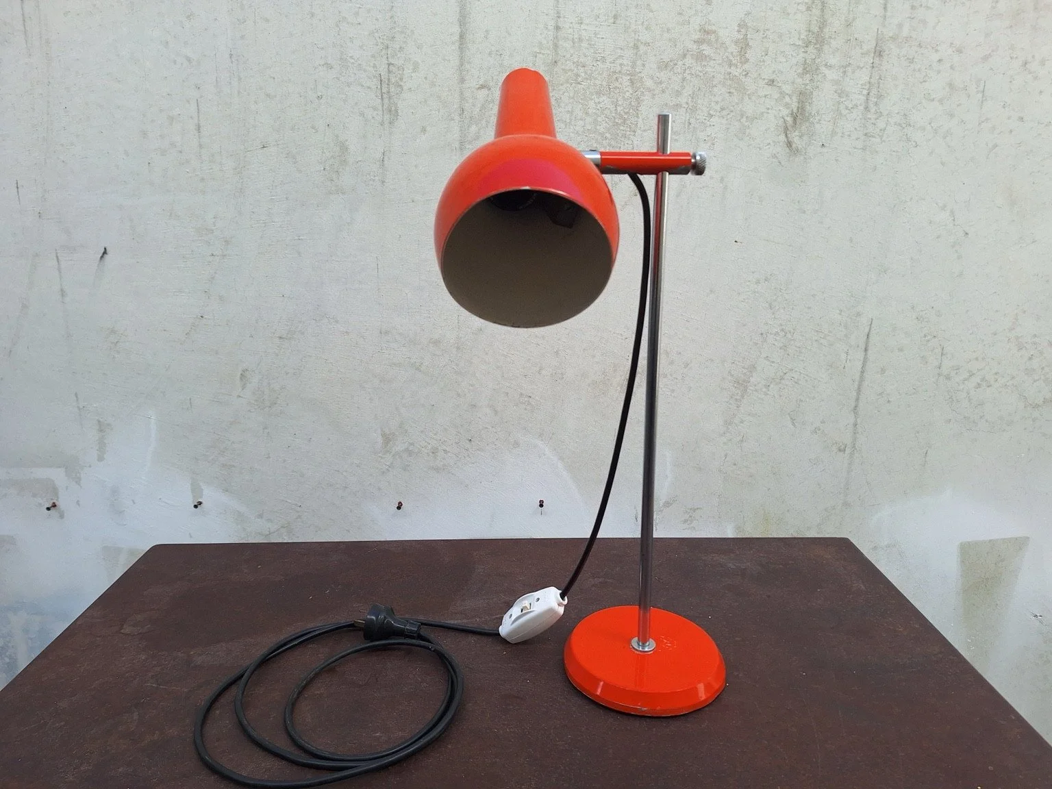 Vintage Oslo orange table lamp with adjustable shade angled downward