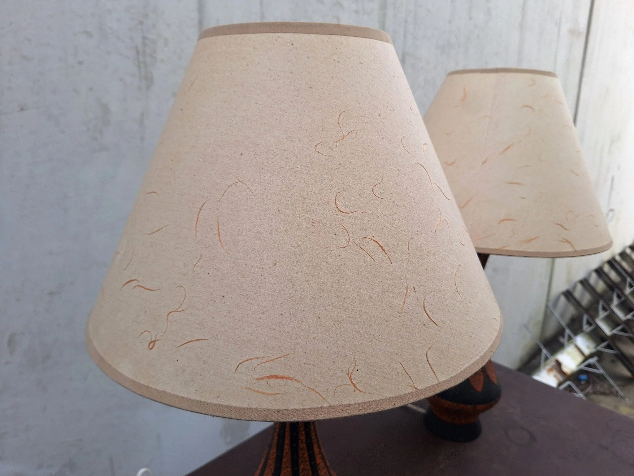 Detail of textured plaster lamp base with orange and black finish.