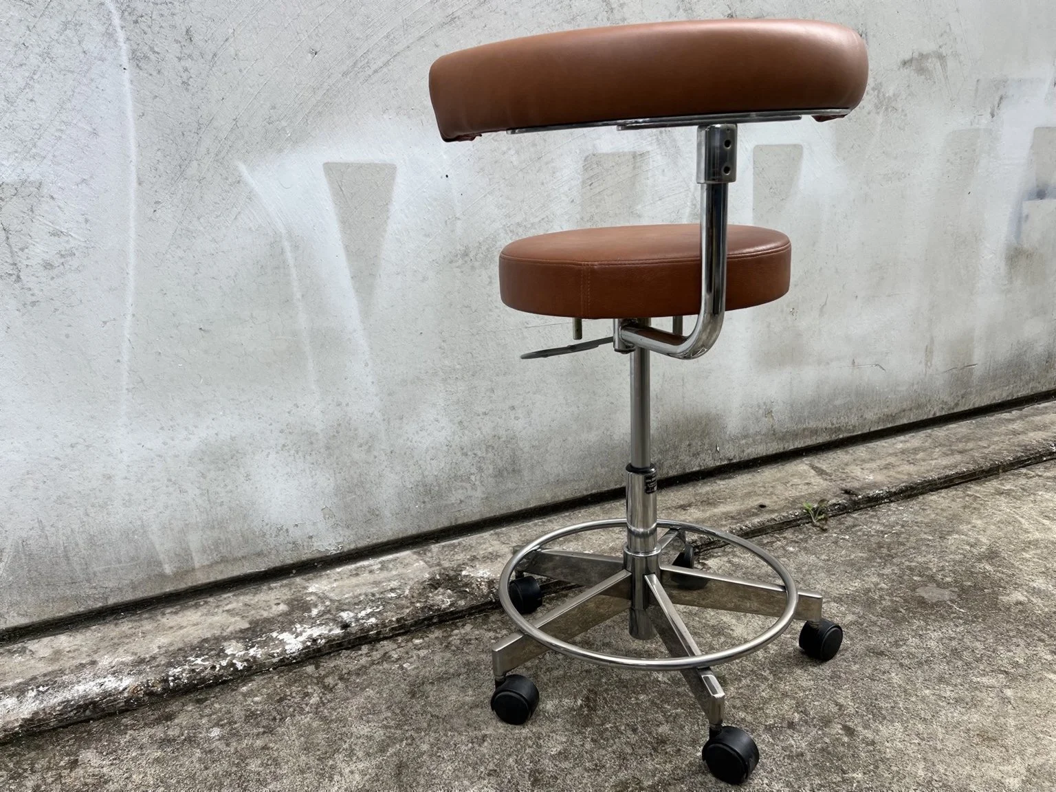Mid century adjustable stool with tan leather seat and chrome base