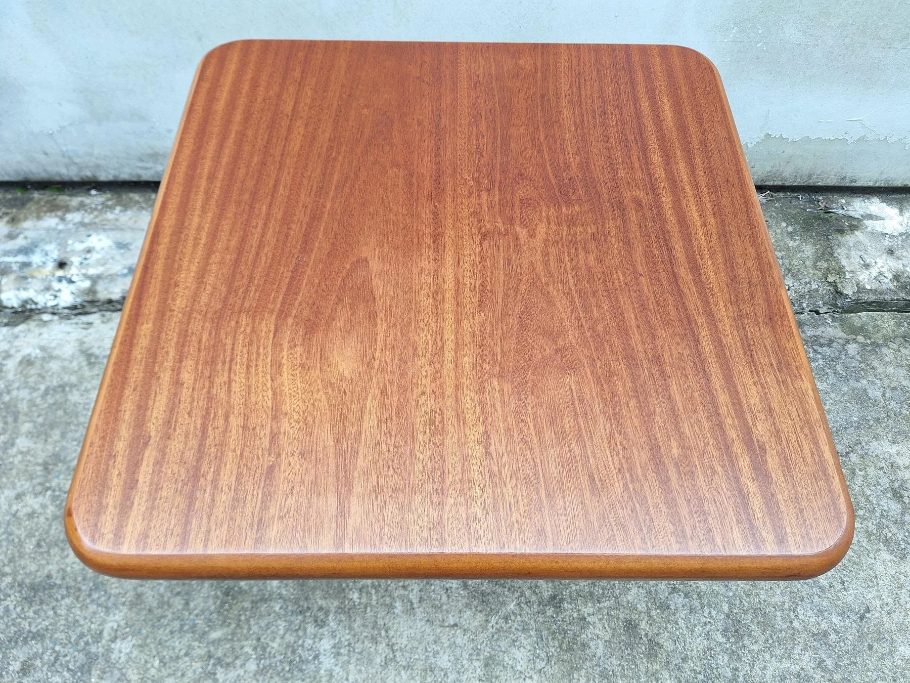 Vintage square timber coffee table with rounded edges and sculptural pedestal base.
