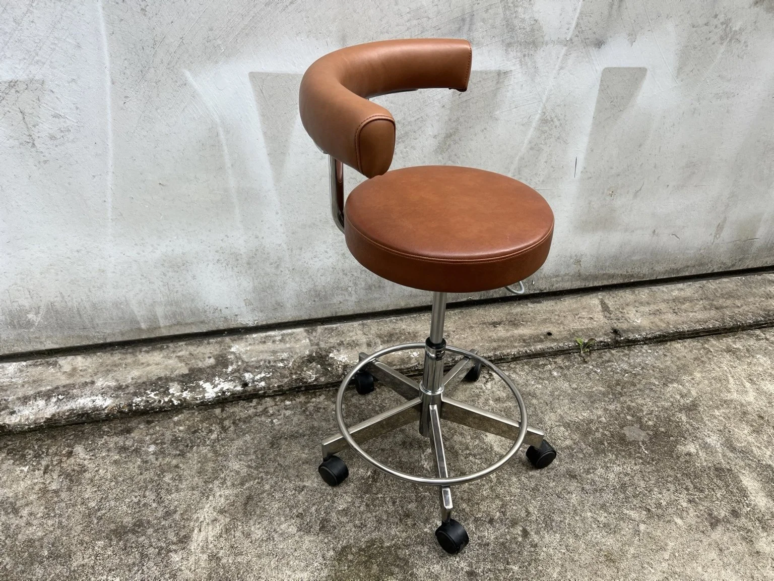 Mid century adjustable stool with tan leather seat and chrome base