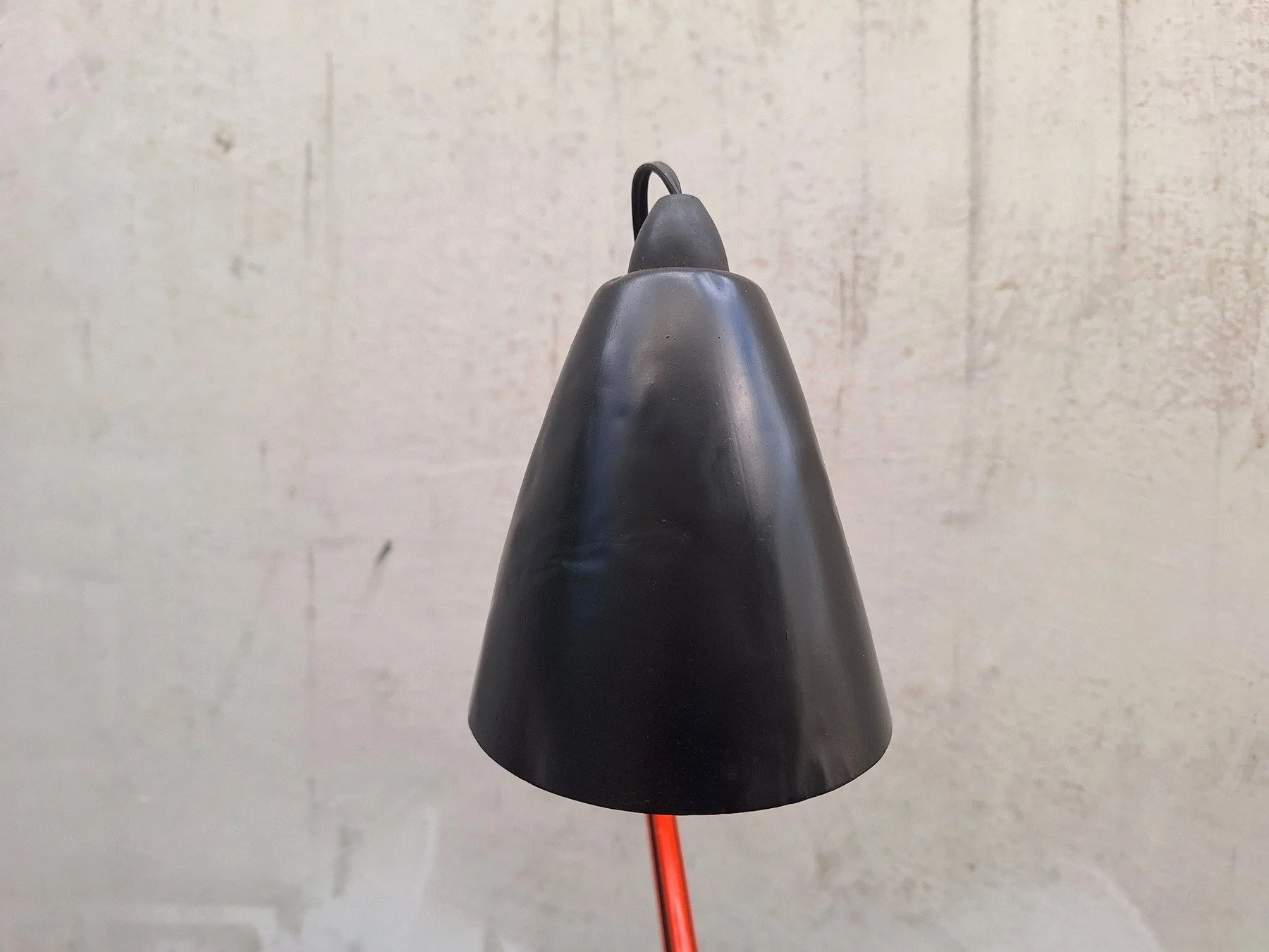 Vintage Planet Studio desk lamp with orange articulated arm, black metal shade and original Planet Products maker's label on weighted base.