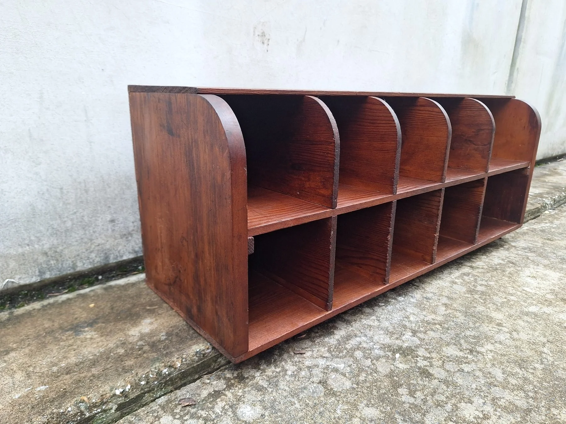 Antique timber letter holder with divided compartments and curved sides.