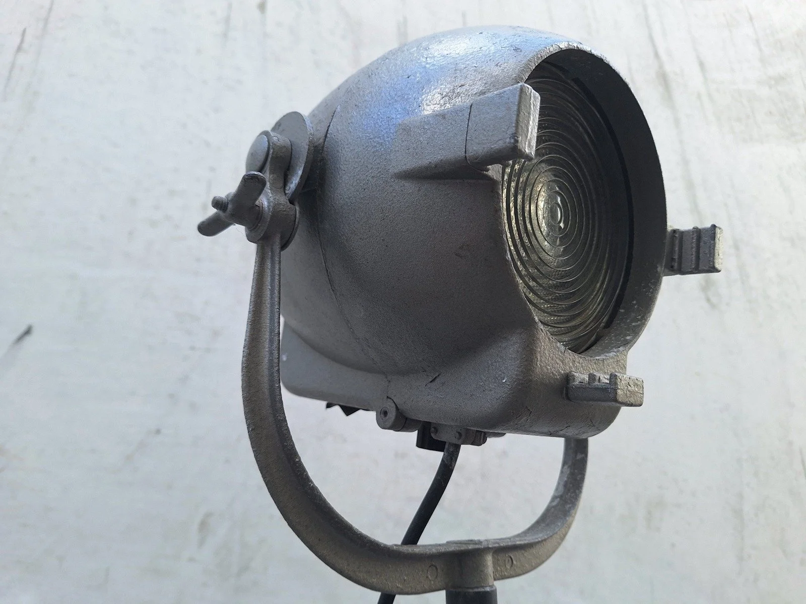Three-quarter view of lamp No. 1 showing the housing, lens and side adjustment knob.