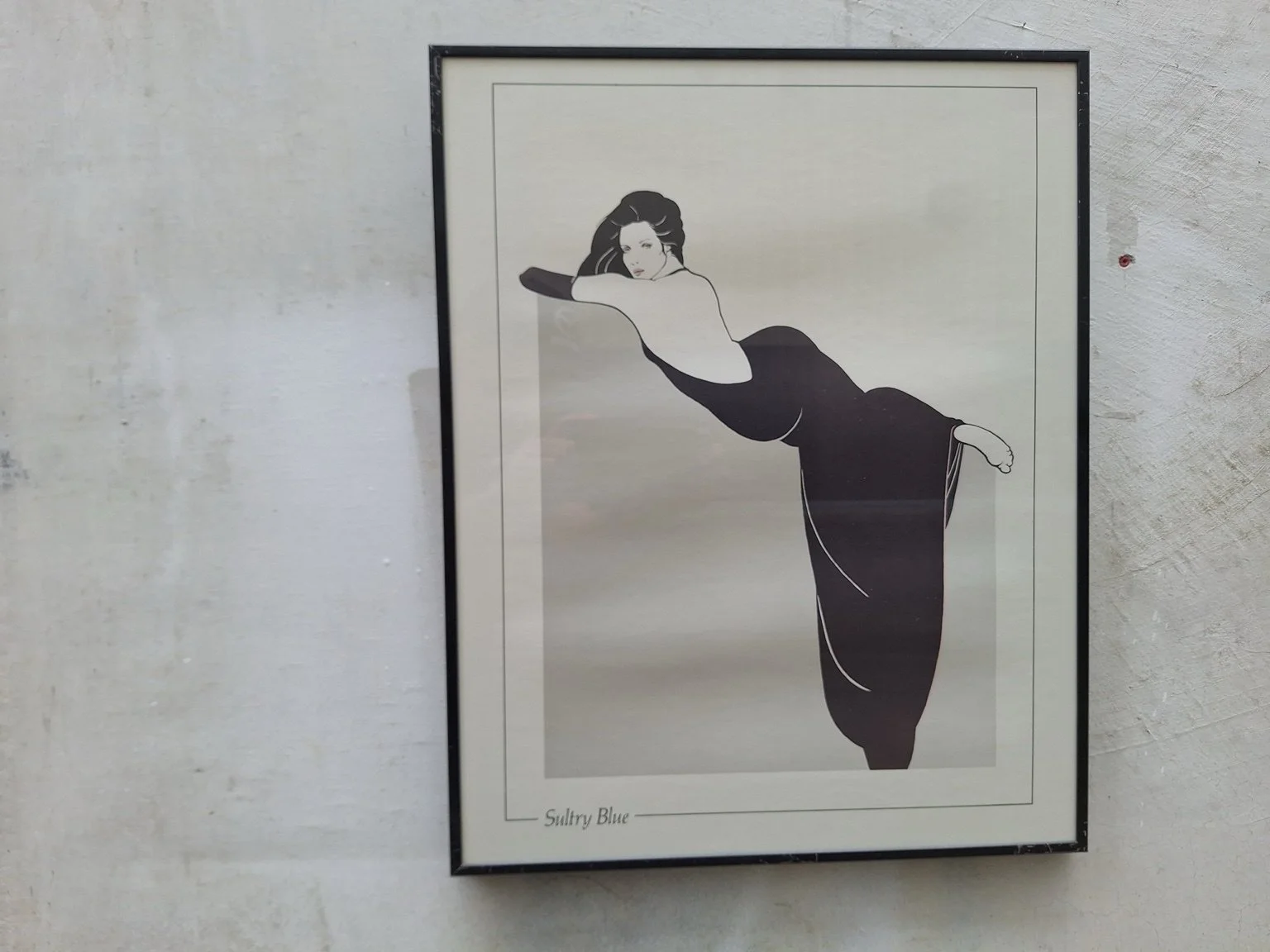 Sultry Blue print depicting a reclining woman in a dark evening gown, in a black frame.