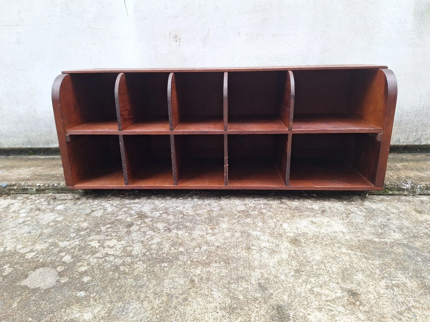 Antique timber letter holder with divided compartments and curved sides.
