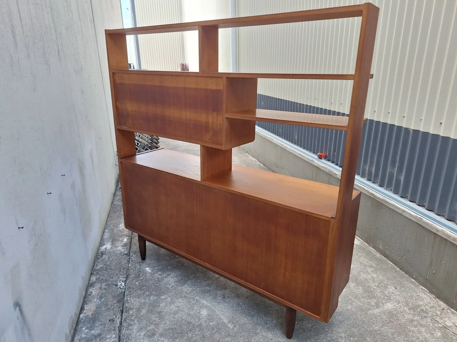 Rear view of the double-sided vintage wall unit configured as a room divider
