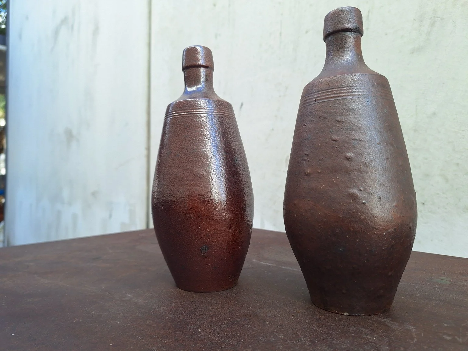 Closer view showing the sculptural profiles and incised shoulder detailing.