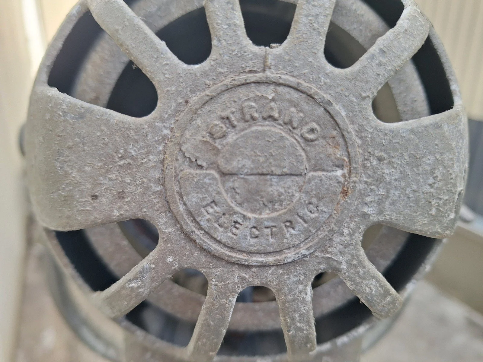 Rear ventilation casting of lamp No. 1 bearing the Strand Electric name.