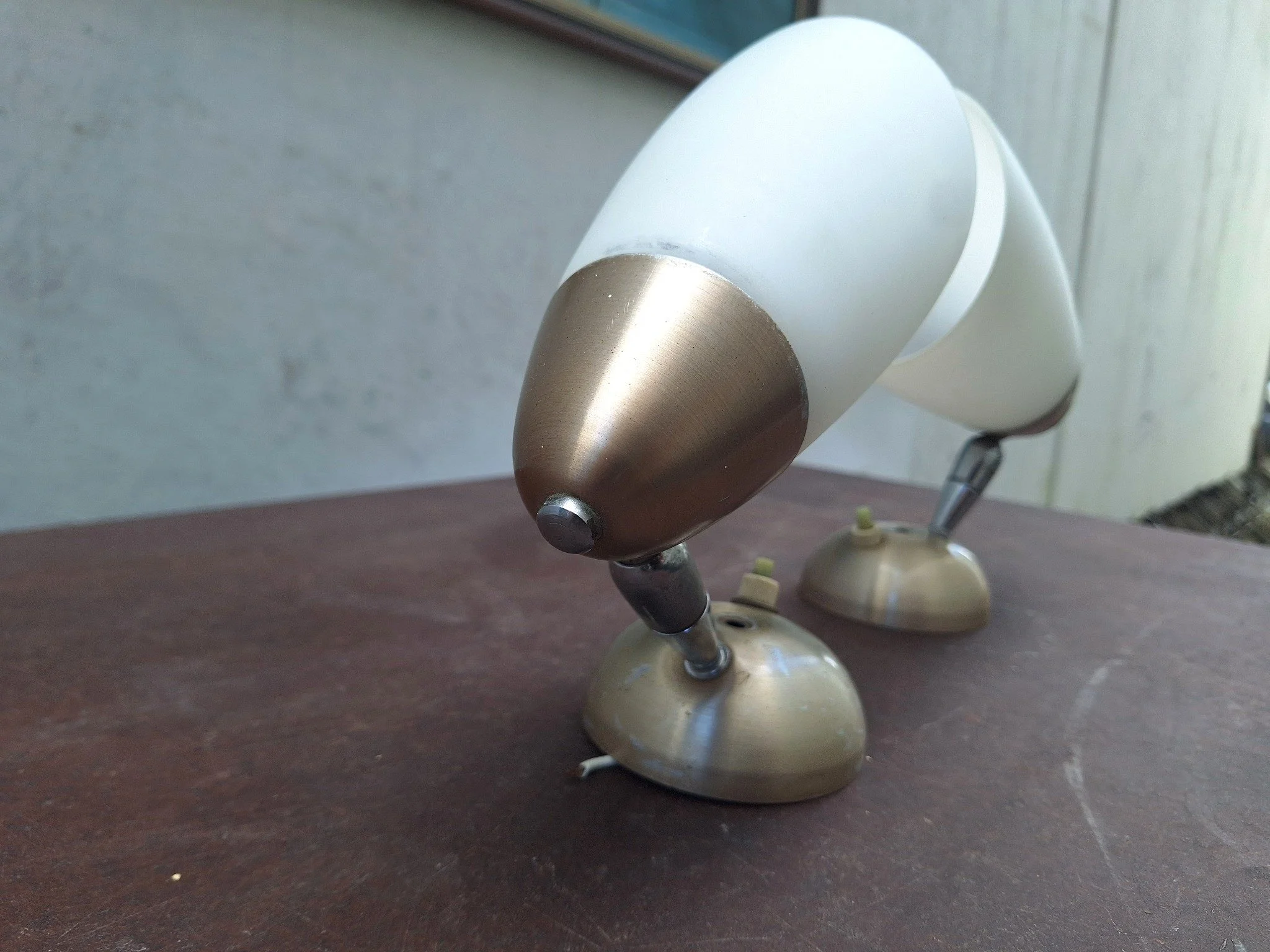 Pair of vintage adjustable wall light fittings with frosted white conical shades, anodised aluminium end caps and wall mounts, and articulated chrome arms.