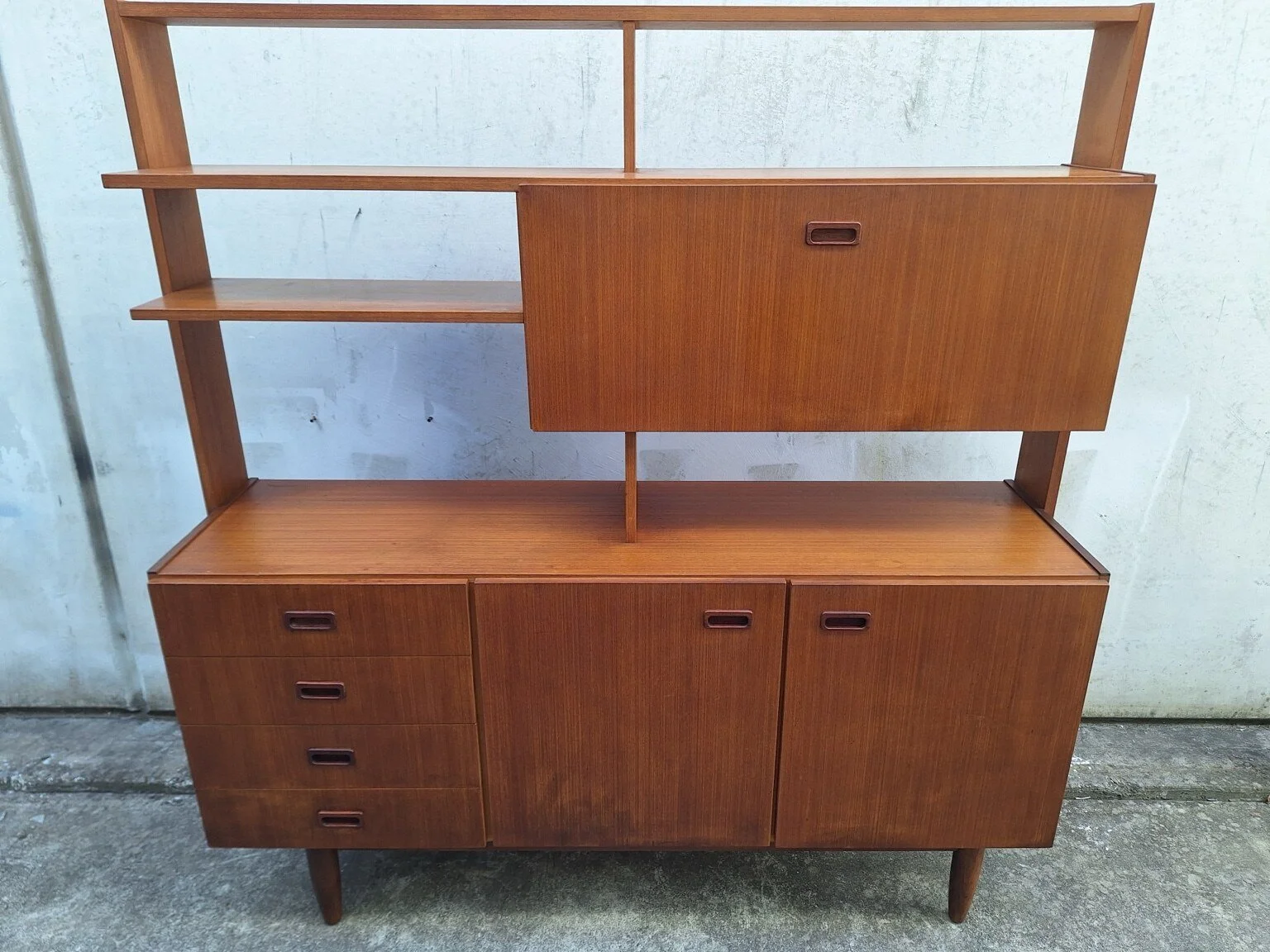 Front view of the vintage timber-veneer wall unit with shelving, drawers and cupboards