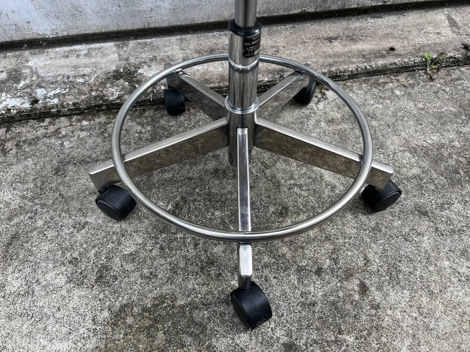 Mid century adjustable stool with tan leather seat and chrome base