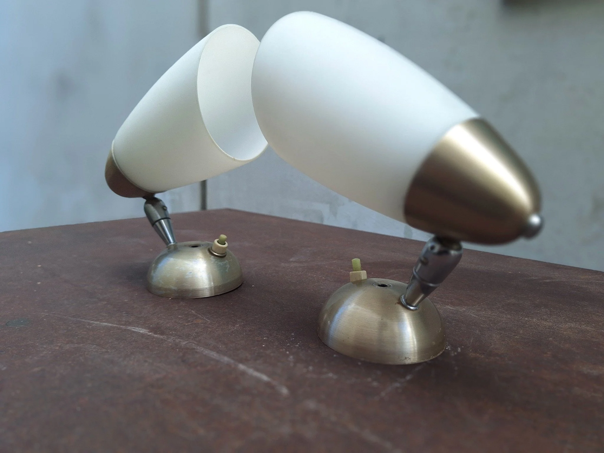 Pair of vintage adjustable wall light fittings with frosted white conical shades, anodised aluminium end caps and wall mounts, and articulated chrome arms.