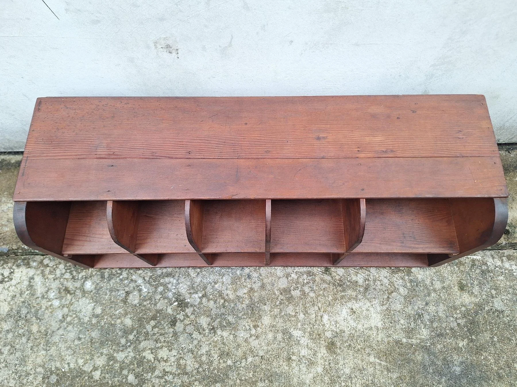Antique timber letter holder with divided compartments and curved sides.
