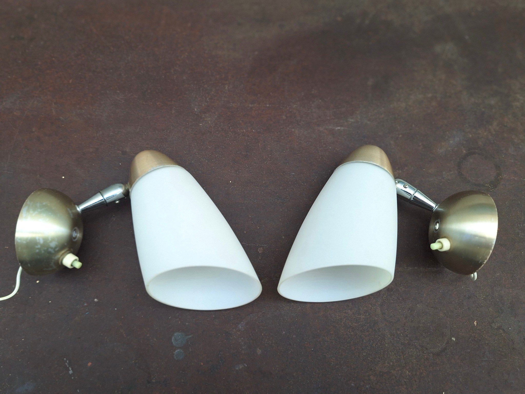 Pair of vintage adjustable wall light fittings with frosted white conical shades, anodised aluminium end caps and wall mounts, and articulated chrome arms.