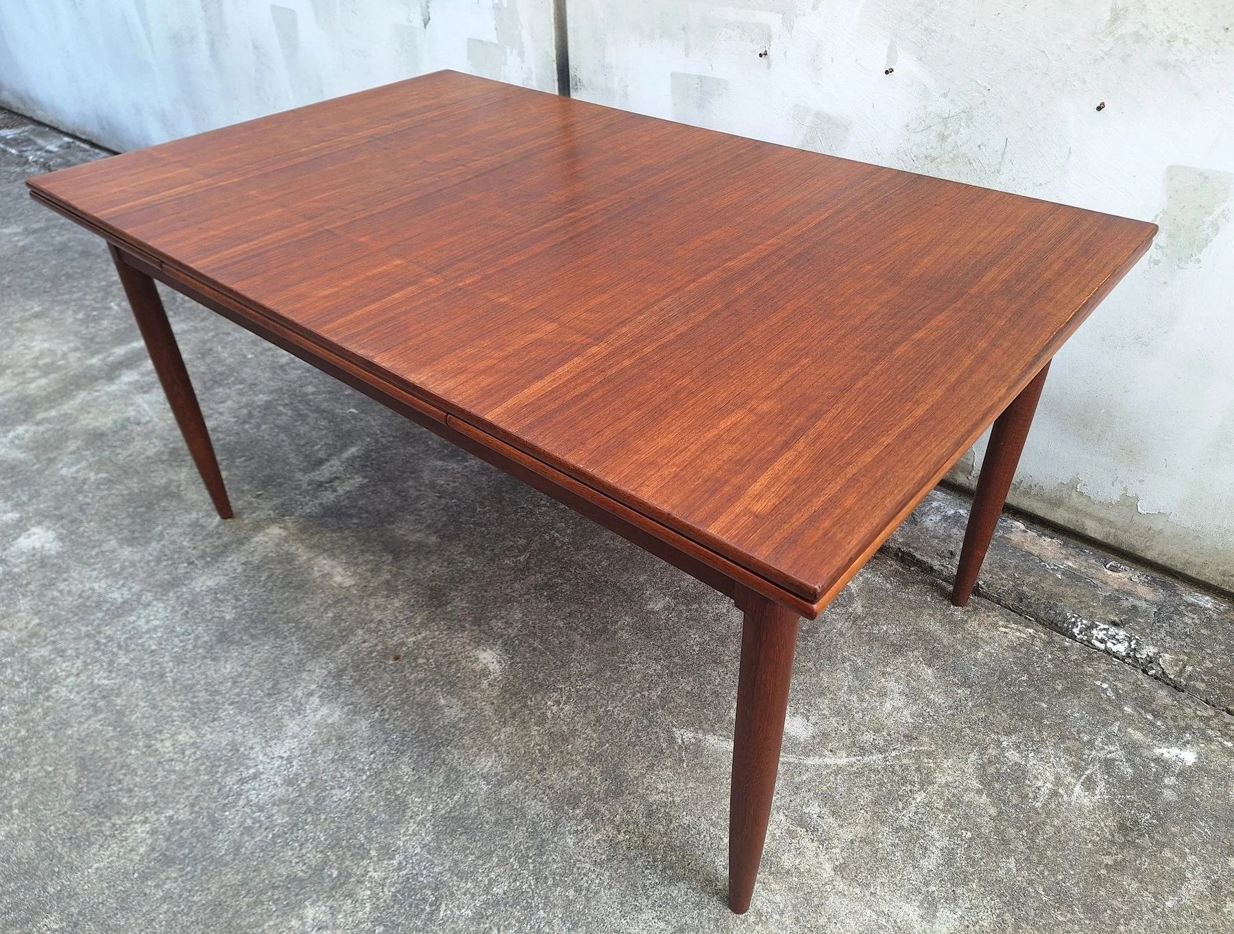 Overhead angled view of the DQF extension dining table in its closed configuration.