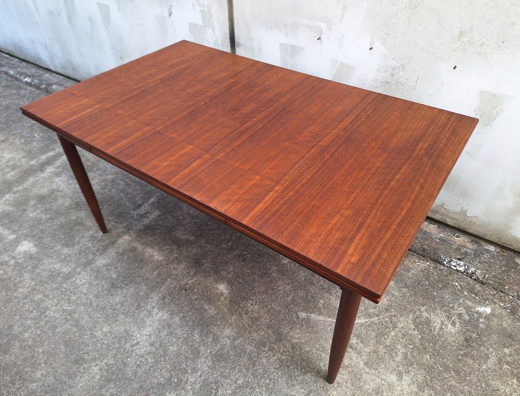 Restored DQF blackbean extension dining table shown closed from an angled view.