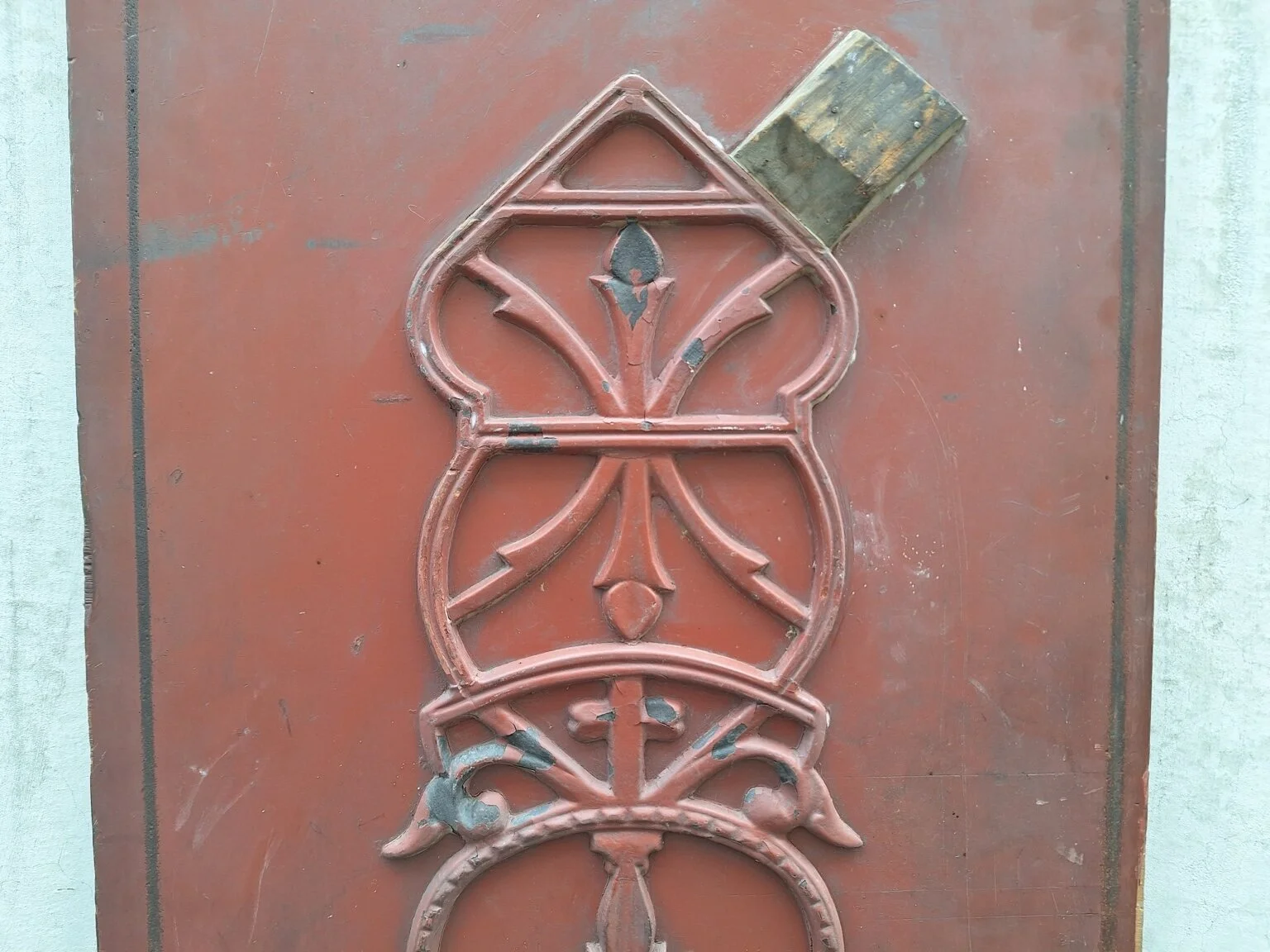 Close view of the upper geometric detail and aged painted surface