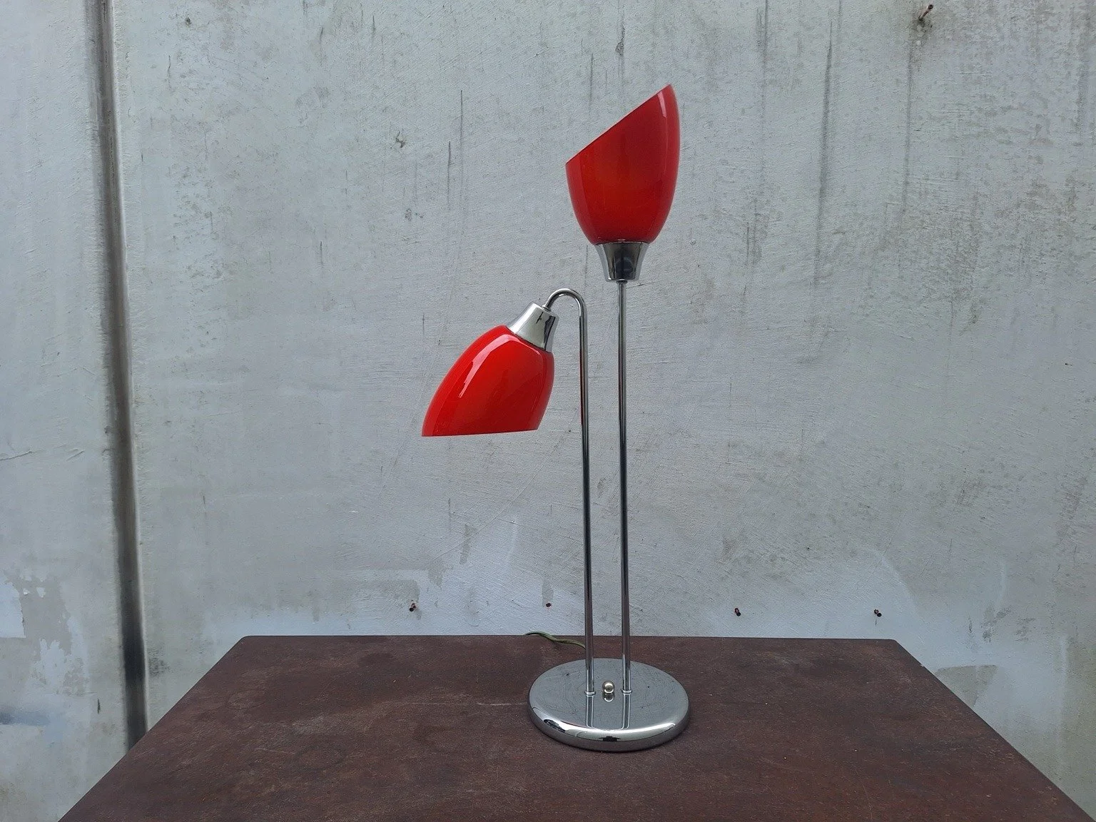 Vintage red twin-shade table lamp with slim chrome stems and a circular base.