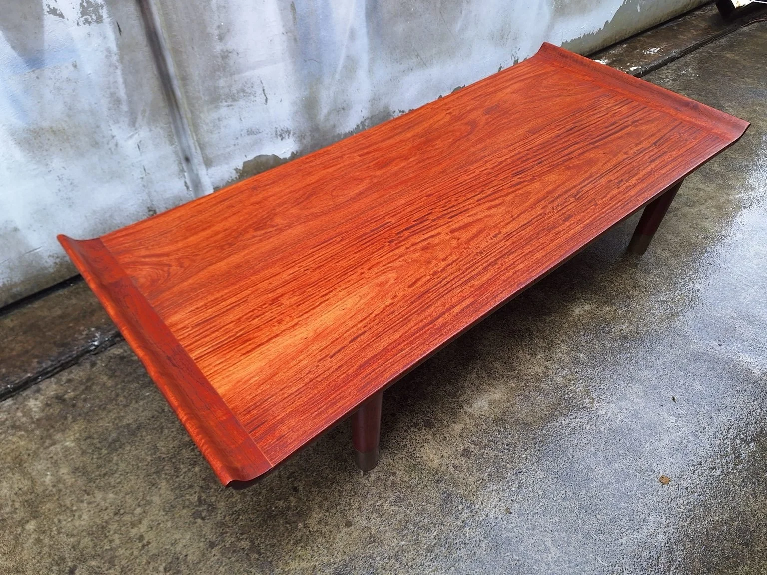 Elevated view showing the rosewood grain across the tabletop.