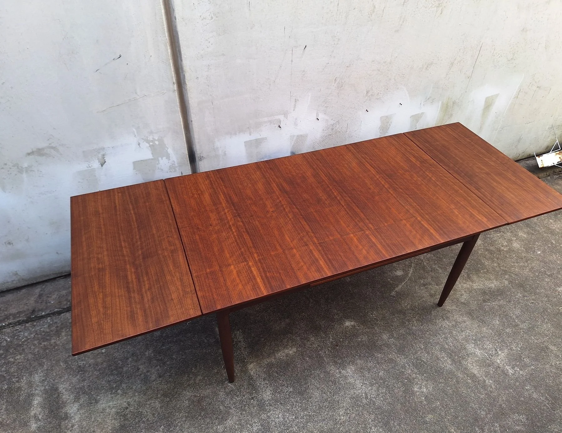 Overhead view of the fully extended blackbean dining table and extension leaves.