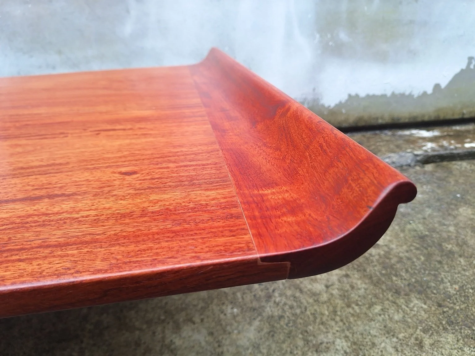 Profile detail of the rolled lip at the end of the coffee table.