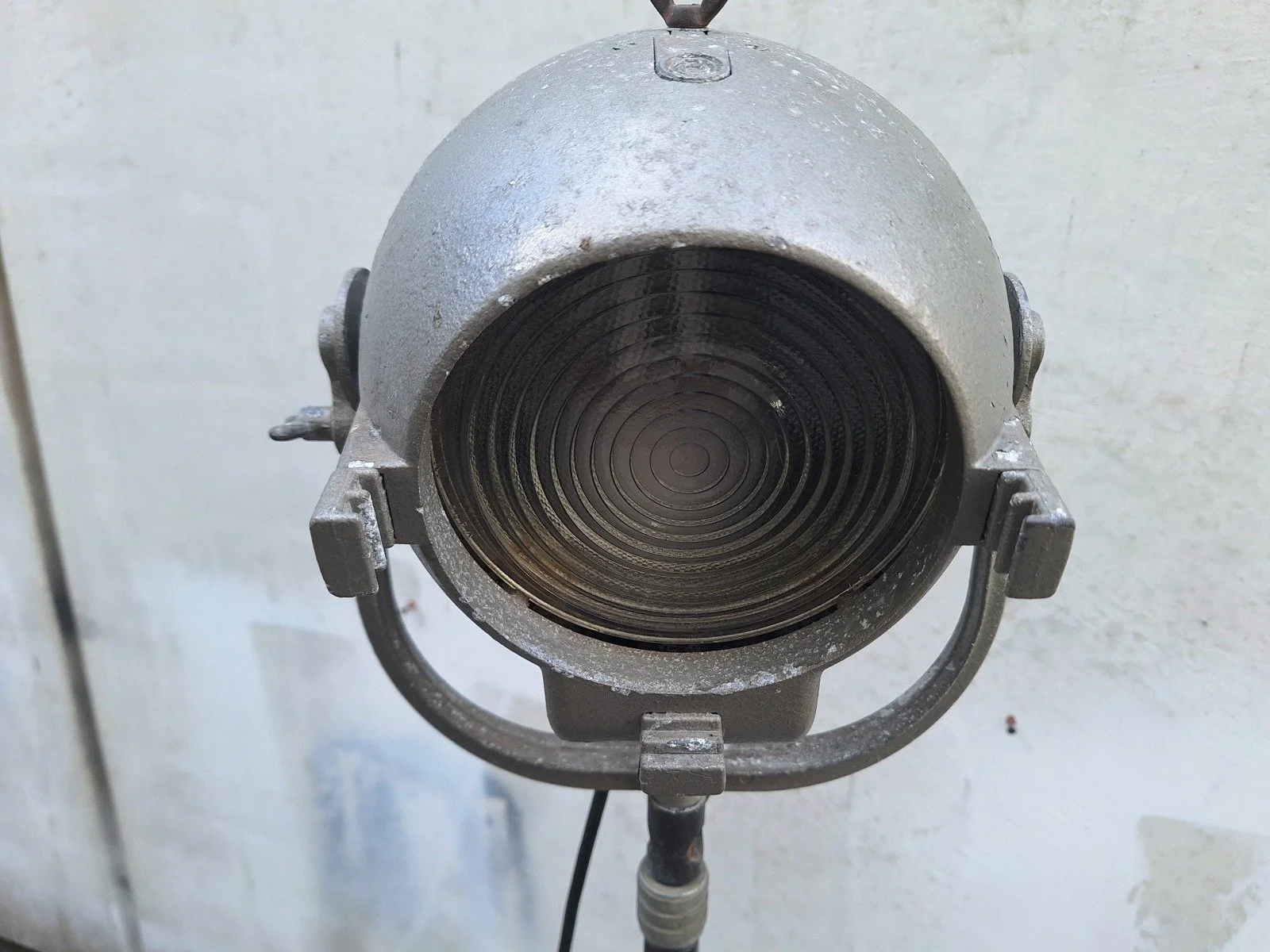 Front view of lamp No. 1 showing the circular ridged glass lens and supporting yoke.