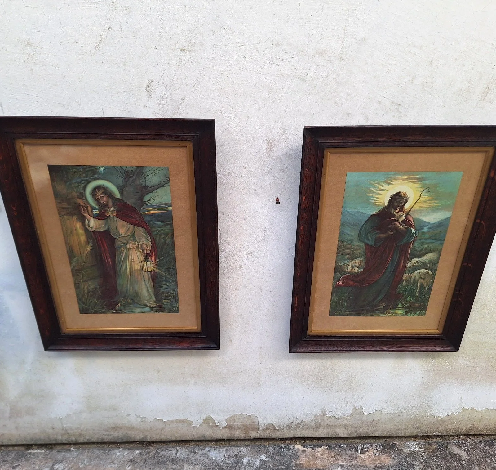 Full view of two vintage Jesus prints in matching silky oak frames