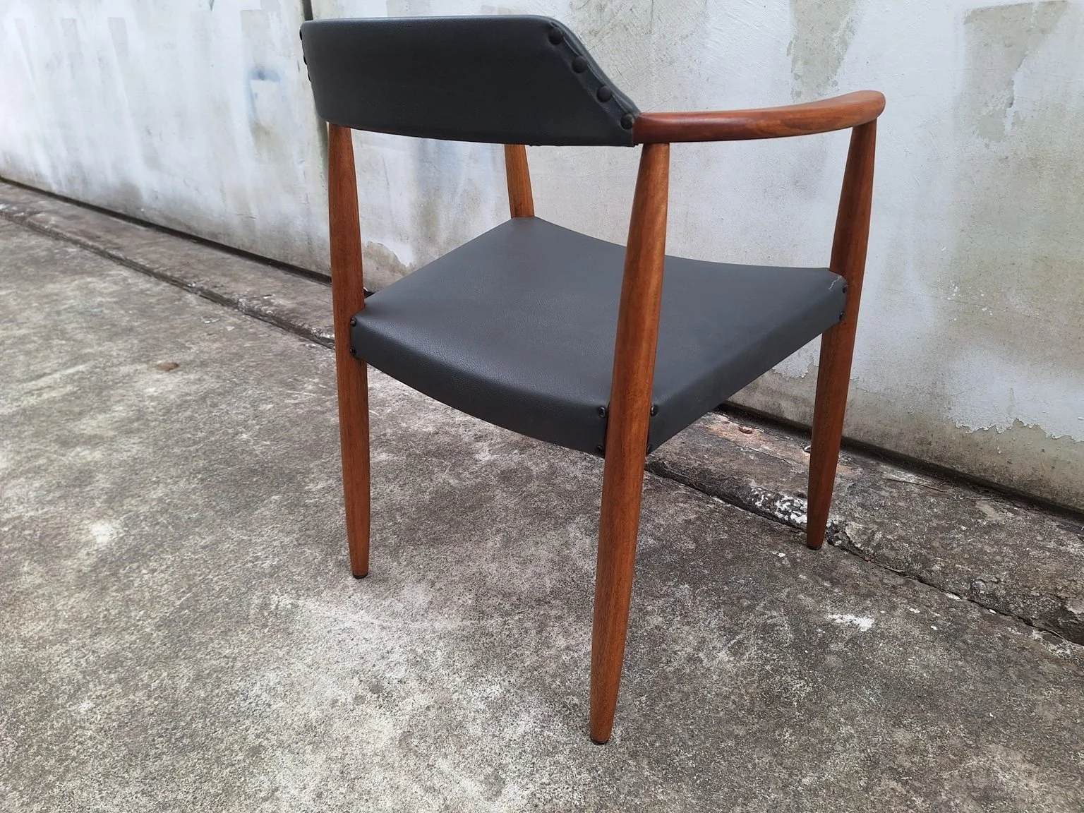 Rear three-quarter view showing the backrest and timber legs.