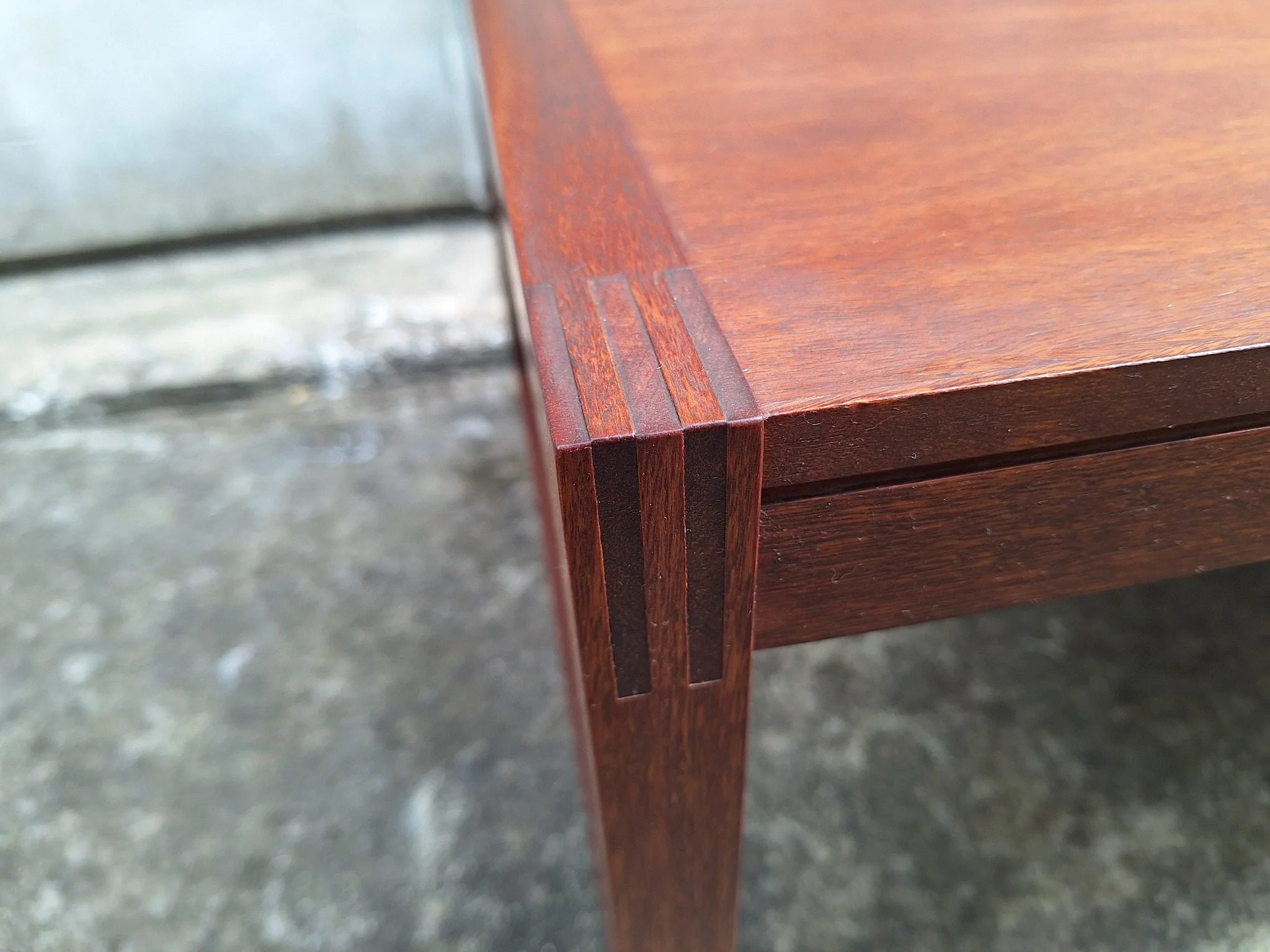 Restored mid century modern teak coffee table with architectural frame and rich teak grain.