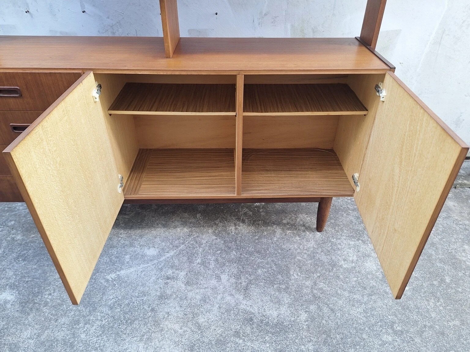 Open lower cupboards showing the internal shelves and storage compartments